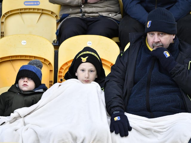 Mansfield Town fans try to keep warm.