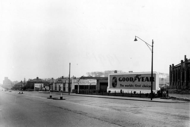 Stanningley Road at its junction with Green Hill View, showing T. Bennett's garage, supplying Regent's petrol in January 1955. A large hoarding advertises Goodyear Tyres.