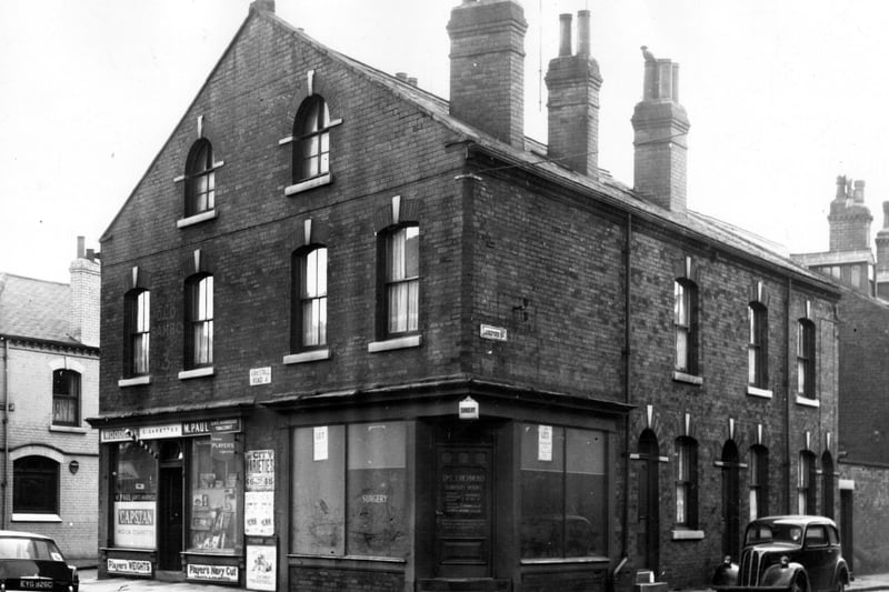 On the left edge of this view, part of the Milford Inn can be seen. Moving right is a barbers and tobacconist business of M. Paul. A striped barbers pole can be seen by the doorway. Number 247 had been the surgery of Dr Leon J. Richmond but is now empty. Langford Street runs to the right edge.