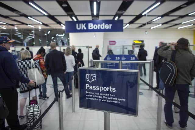 Border Force check the passports of passengers arriving. Photo: Getty Images