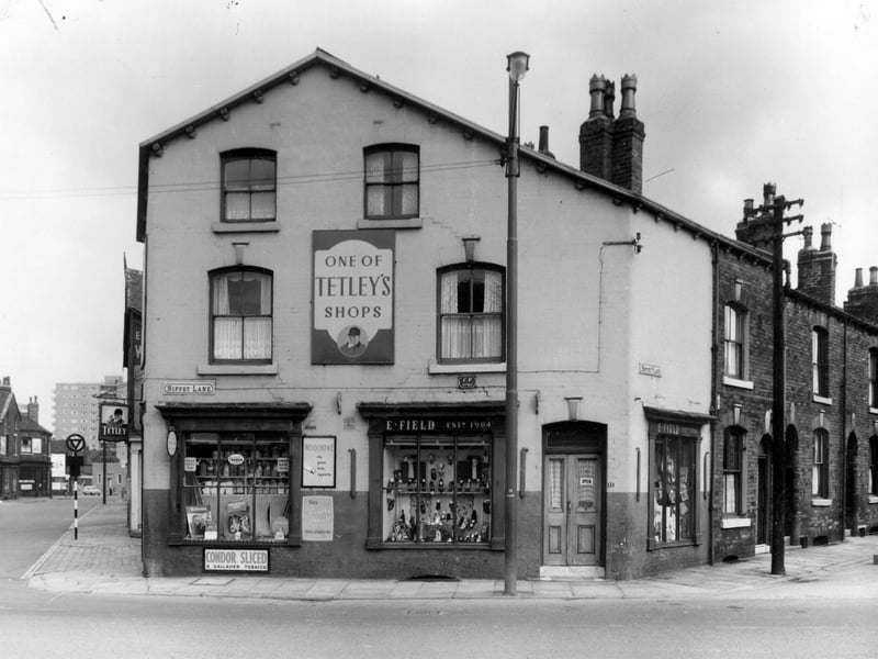 Accommodation Road is on the left, this is the point where it crossed Nippet Lane, which is going to the right. The off-licence shop with the sign for Tetley's beer faced onto Accommodation Road. Next, shoe shop, business of E. Field was 11 Nippet Lane, shop had operated since 1904. To the right Nippet Place can be seen.