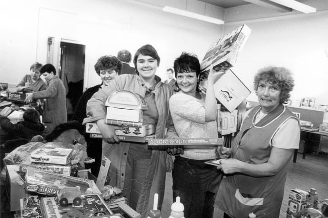 This photo was taken at the Wykebeck Community Centre during one of two 'Family Allowance' Toy Fairs in December 1984. The other was held on the same day at the Henry Barran Centre. Local residents in possession of a Family Allowance book were able to buy new and quality second-hand toys as Christmas presents for their children. These were offered at a much cheaper price than in the shops, sometimes between only 10p and 25p. Many toys were donated to the committees and toy wholesalers gave substantial discounts. The Christmas Toy Bonanza was held annually.