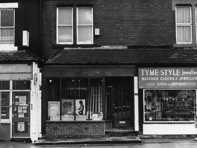 Harehills Lane showing part of a row of shops. On the right is Tyme Style Jewellers, then in the centre is the Anglia Building Society while on the left is a newsagent.