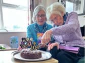 Jean cutting her cake