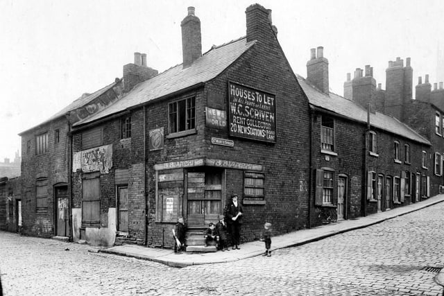 The junction of Mabgate, left, with St. Mary's Street, right, in September 1919. Children gather on the corner in front of a shop which is boarded up (B. Bianchi's) as are other properties on Mabgate. These very old cruck framed timber houses, which could even be from the medieval period, were due to be demolished. Rows of brick built two-storey back-to-back terraced houses lead up the hill on St Mary's Street.
