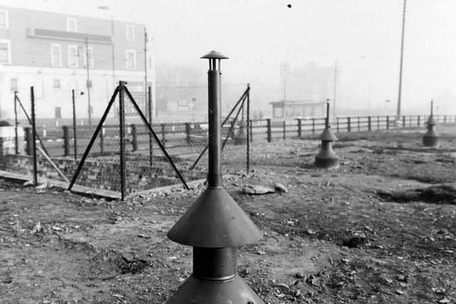 An air raid shelter, situated opposite the Shaftesbury Cinema, junction of York Road and Harehills Lane in November 1941. The entrance to the shelter can be seen on the left. A series of metal air vents mark the path of the underground construction.