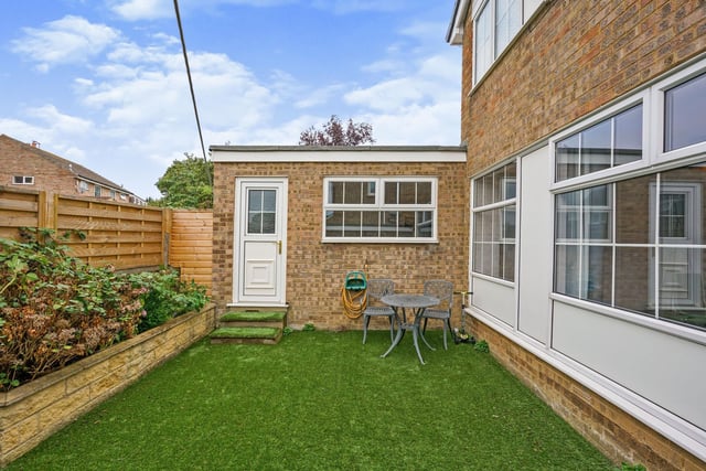To the outside is a mature garden with a lawned area and flower borders, plus a driveway with off street parking for two cars.