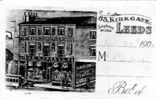An advertising postcard, dating from January 1902 with engraved picture of premises of C. Russell, Wholesale Tobacconist, 83 Kirkgate, Leeds, telephone number 1764, to Mr. Parkiss; selling Hignetts Reliable Tobaccos.
