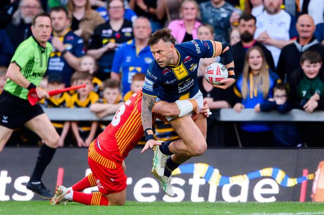 Leeds Rhinos' Chris Hankinson is tackled by Catalans Dragons' Ben Garcia. Picture by Allan McKenzie/SWpix.com.