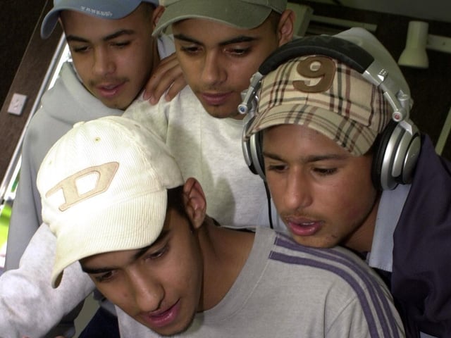 Sageer Saleem with Leon Winspear, Kulwinder Manku and Kamar Aunin scratch and mix records at a summer roadshow staged at Cross Flatts Park in August 2002.