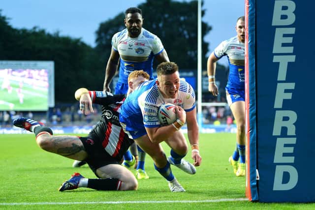 Callum Mclelland scores for Rhinos against Salford in July, 2021. Picture by Jonathan Gawthorpe.