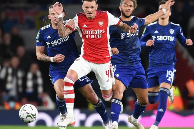 LONDON, ENGLAND - OCTOBER 26: Ben White of Arsenal takes on (L) Kalvin Phillips and (R) Tyler Roberts of Leeds during the Carabao Cup Round of 16 match between Arsenal and Leeds United at Emirates Stadium on October 26, 2021 in London, England. (Photo by Stuart MacFarlane/Arsenal FC via Getty Images)