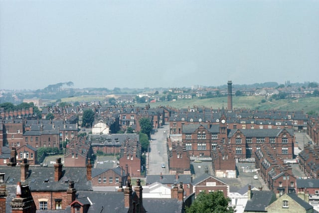 A view of Woodhouse taken from Leeds University Engineering Department, centred on Pennington Street. Quarry Mount Primary School is on the right at the junction with Cross Quarry Street, with Bolland Street, Thomas Street and Quarry Place running down below it to Woodhouse Street in the foreground. On the left, Pennington Grove and Pennington Terrace lead up from Pennington Place, with the Providences further back. The chimney of the Meanwood Road Refuse Destructor can be seen in the background. Pictured in June 1975.