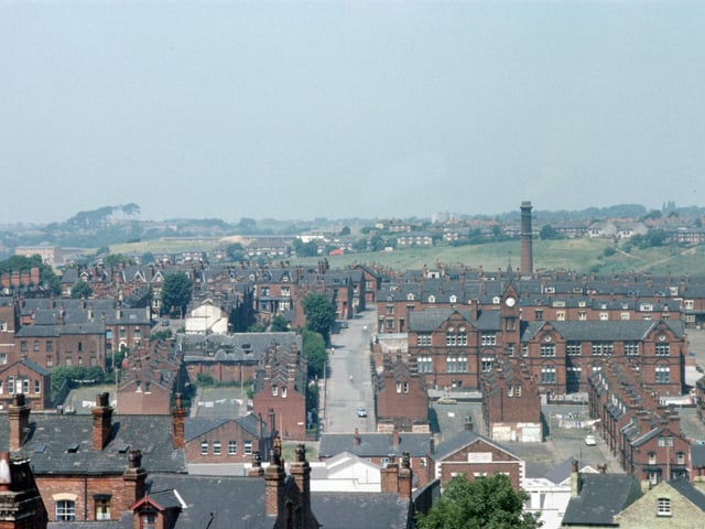 A view of Woodhouse taken from Leeds University Engineering Department, centred on Pennington Street. Quarry Mount Primary School is on the right at the junction with Cross Quarry Street, with Bolland Street, Thomas Street and Quarry Place running down below it to Woodhouse Street in the foreground. On the left, Pennington Grove and Pennington Terrace lead up from Pennington Place, with the Providences further back. The chimney of the Meanwood Road Refuse Destructor can be seen in the background. Pictured in June 1975.