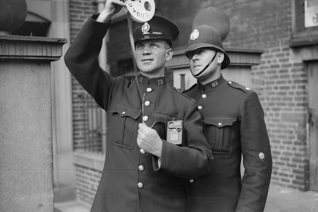 Chesterfield police photographer PC Sanders shows some film to his assistant Police Constable Wheatcroft in 1935.