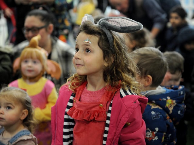 Nina Jezienska, five, of Middleton, sporting Easter bunny ears as she met the characters