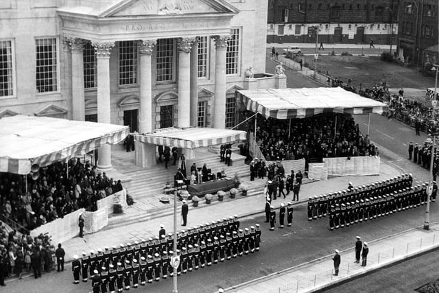 Granting of the Freedom of the City of Leeds to H.M.S. Ark Royal, Her Majesty according the honour in October 1973. This view is of Leeds Civic Hall. The Royal party is in the centre, with two temporary stands for guests. The Queen Mother spoke of her association with Ark Royal, recalling that she had launched the ship in Birkenhead 23 years previously. 400 members of the ships company were present, from the total of 2,500 crew. They were accompanied by the combined bands of the Commander-in-Chief Fleet and Ark Royal. A march past took them from the Civic Hall through the City Centre. There was also a flypast by 26 aircraft from the ship.