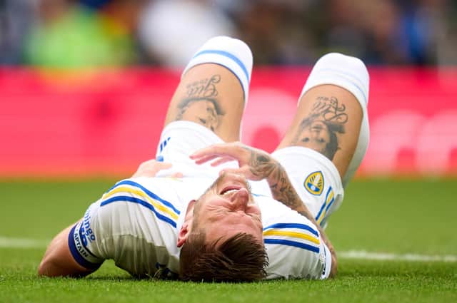 Liam Cooper is injured during Leeds' opening fixture of the 2023/24 season. (Photo by Alex Caparros/Getty Images)