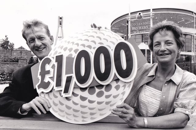 £1,000 gift. Tetley's director Graham Kershaw and Tina Emmott of the Anthon y Nolan Bone Marrow Trust launch a charity golf tournament in June 1994.
