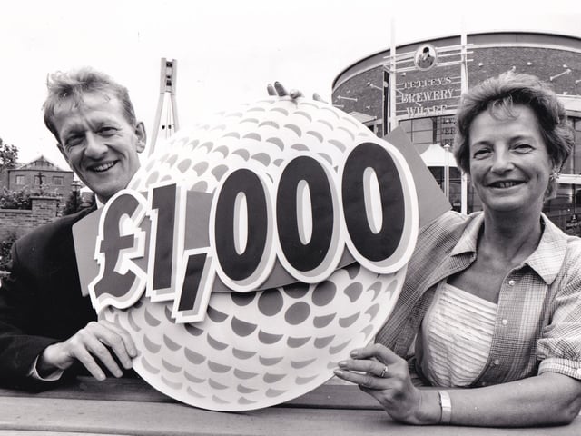 £1,000 gift. Tetley's director Graham Kershaw and Tina Emmott of the Anthon y Nolan Bone Marrow Trust launch a charity golf tournament in June 1994.