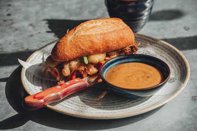 The menu features a Philly steak sandwich with peppers, onions and melted cheese, served with lashings of peppercorn sauce.