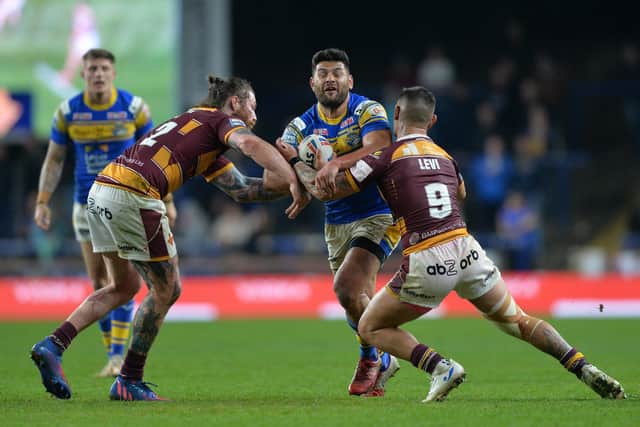 Rhinos' Rhyse Martin is tackled by Huddersfield duo Chris McQueen and Danny Levi, two players Rohan Smith has coached in the past. Picture by
Bruce Rollinson.