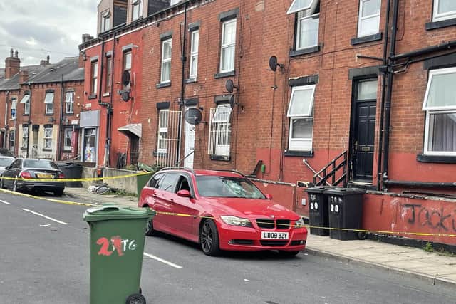 A scene, including a car, was identified and remains cordoned off as forensic examinations continue.
