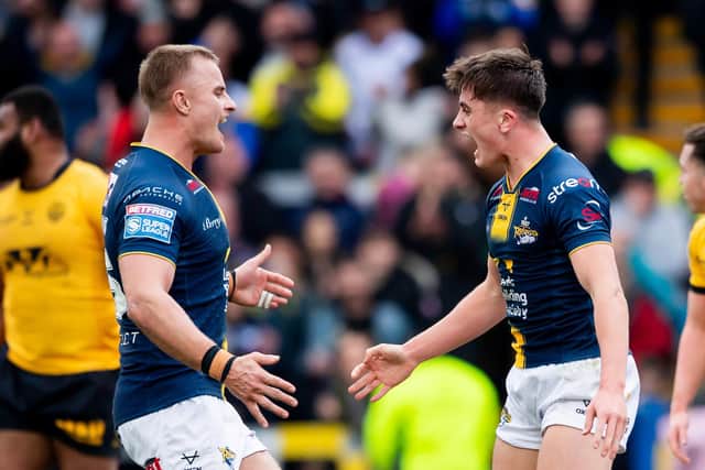 Teenage stand-off George Brown, right, is congratulated by teammate Cooper Jenkins after scoring Leeds Rhinos' first try in the 22-4 win against Castleford Tigers on Sunday. Picture by Allan McKenzie/SWpix.com.