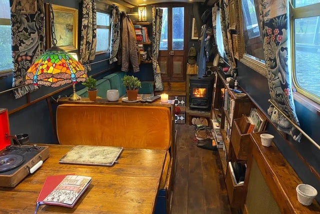 The interior of the boat is delightfully cosy, comprising a sofa area with TV and bookcase, a dining booth, a kitchen and a bedroom, all carved out of reclaimed wood by a Brazilian cabinet maker.