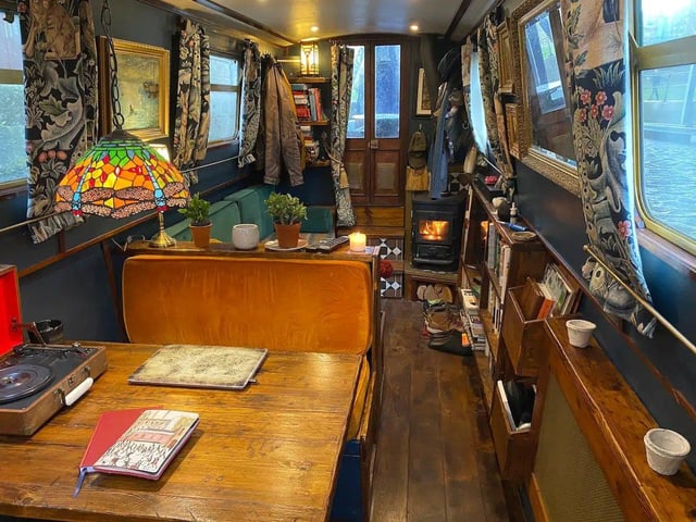 The interior of the boat is delightfully cosy, comprising a sofa area with TV and bookcase, a dining booth, a kitchen and a bedroom, all carved out of reclaimed wood by a Brazilian cabinet maker.