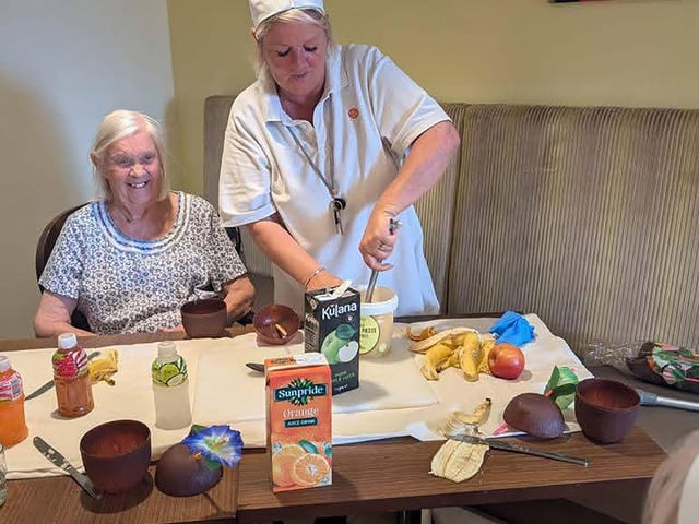 Resident and colleague enjoying cocktail and mocktail bar making workshop at HC-One’s Augustus Court Care Home during Care Home Open Week