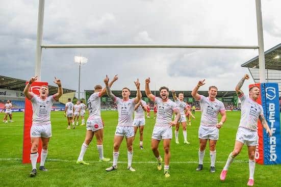 Rhinos players celebrate their win at Salford in July. Coach Rohan Smith has hailed the spirit shown by his side during a "turbulent" year. Picture by Olly Hassell/SWpix.com