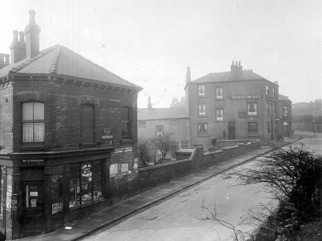 The junction with Buslingthorpe Lane, Tetleys' public house, the Skinners Arms, landlord Walter Watson. Shop, run by Mrs. R. Pearson, corner building. Enamel wall signs include 'Pilot' matches. 'Parkinsons' pills. Pictured in March 1930.