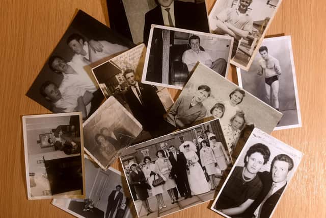 Anne Pearce looks through photographs of her father John.