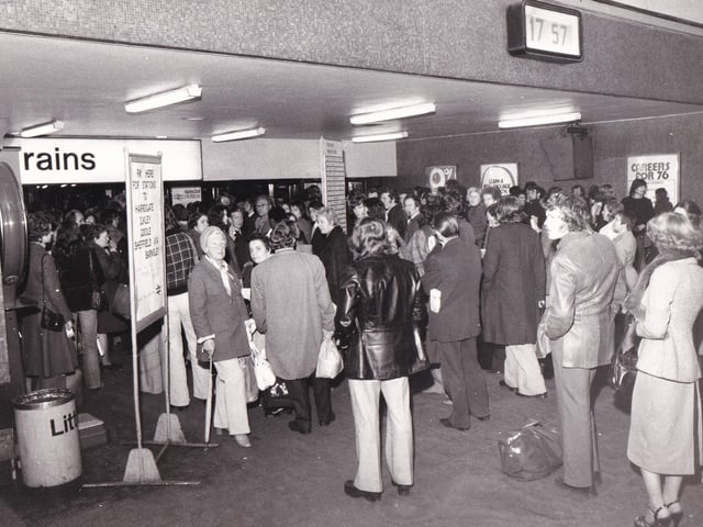 Passengers wait at barriers in Leeds City Station after a bomb alert in November 1975.
