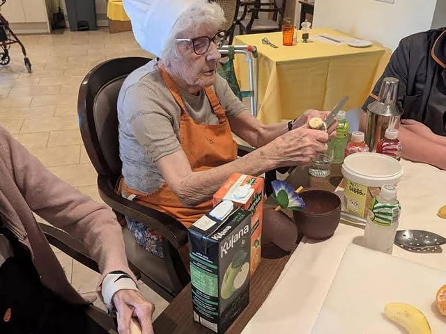 Resident enjoying cocktail and mocktail bar making workshop at HC-One’s Augustus Court Care Home during Care Home Open Week
