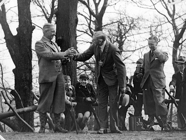 The Lord Mayor of Leeds, Alderman Robert H Blackburn (centre) is being presented with a memento by Alderman Alf Masser (left) while young boys look on.