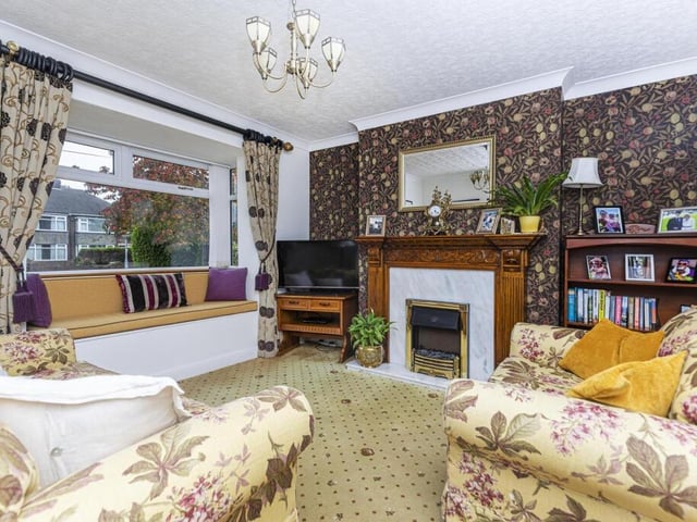 Another striking fireplace in this ground floor room that also has a built-in window seat.
