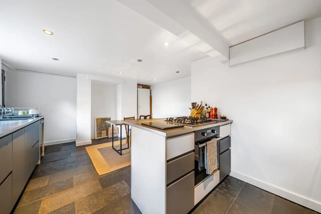 One of the standout features of this property is the meticulously converted kitchen located in the cellar, which has been transformed into a functional and stylish area.