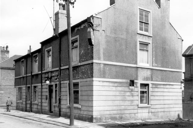 The Pheasant Inn on Kiln Street, a Ramsdens Ale House. Far left just above the man with the walking stick is the sign for Tunis Street, a right turn beyond the public house.