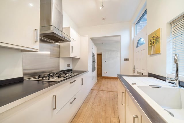 The kitchen is well equipped with a variety of wall and base units, integrated appliances, a five-ring gas hob and extractor.