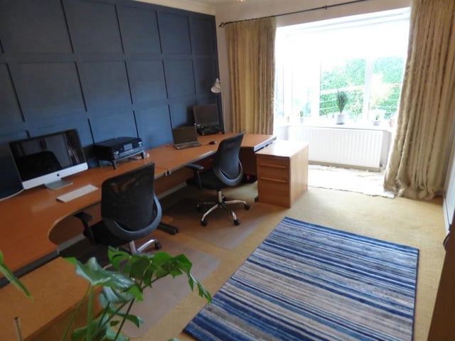 This office is spacious and has views of the garden.