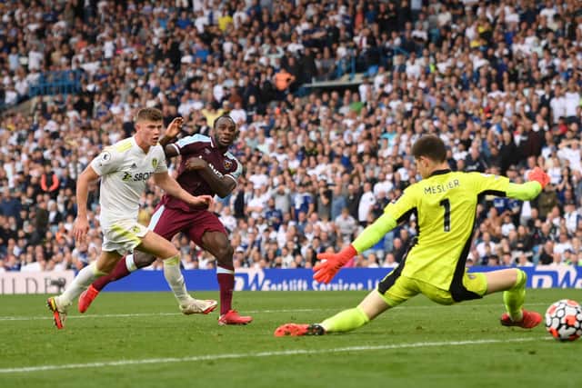 LEEDS, ENGLAND - SEPTEMBER 25: West Ham striker Michail Antonio shoots to score the winning goal past Leeds goalkeeper Illan Meslier as defender Charlie Cresswell looks on during the Premier League match between Leeds United and West Ham United at Elland Road on September 25, 2021 in Leeds, England. (Photo by Stu Forster/Getty Images)