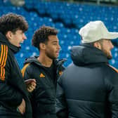 FEELING SHARP: Leeds United's USA international star Tyler Adams, centre, pictured sitting out Tuesday evening's open training session for Mission Christmas alongside Archie Gray, left, and Jack Harrison, right. Picture by James Hardisty.