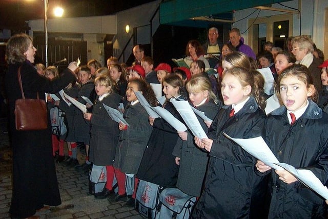 Froebelian School Choir, Horsforth Choral Society and the Horsforth Leeds City Band sang Christmas carols outside Fat Francos restaurant on New Road Side in December 2003.