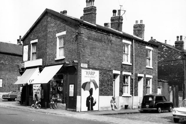 A newsagents on the corner of Cambridge Road and Oakfield Street in August 1967. To the right is Ashfield Street with two children outside a house.