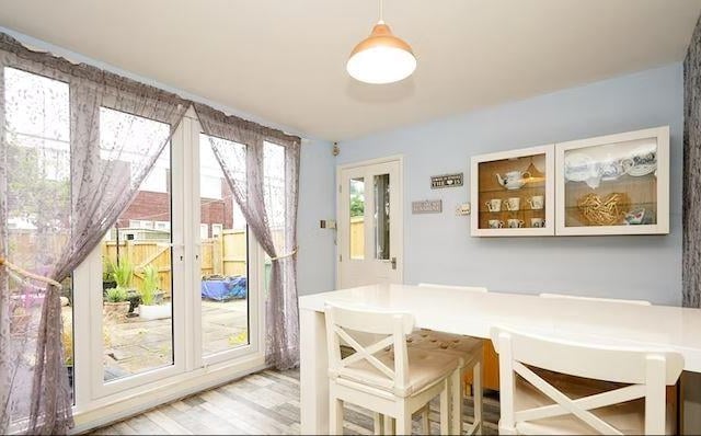 The property boasts a separate dining area with french doors leading into the garden.