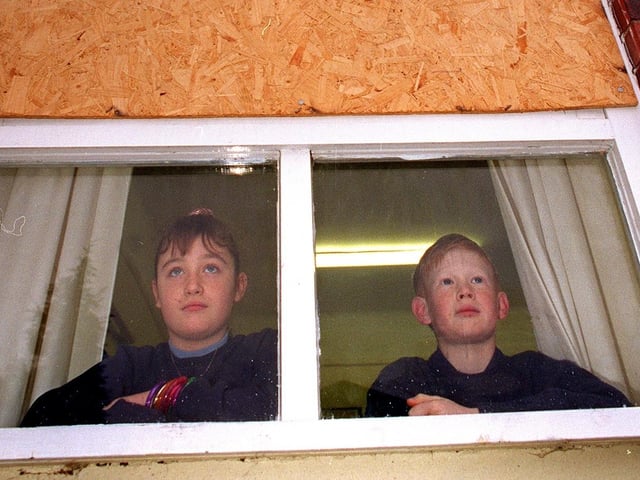 Pupils Amy Garner and Richard Summesgill at Crossgates Primary showing some of the boarded-up windows at the school. Pictured in January 1997.