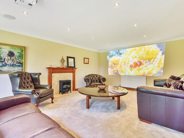 The cottage lounge doubles as a cinema room for the occupants of the main house when not in use.
