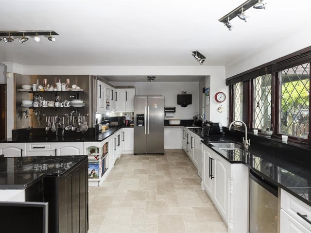 This high spec kitchen comes with integrated appliances, with high gloss units and granite worktops.